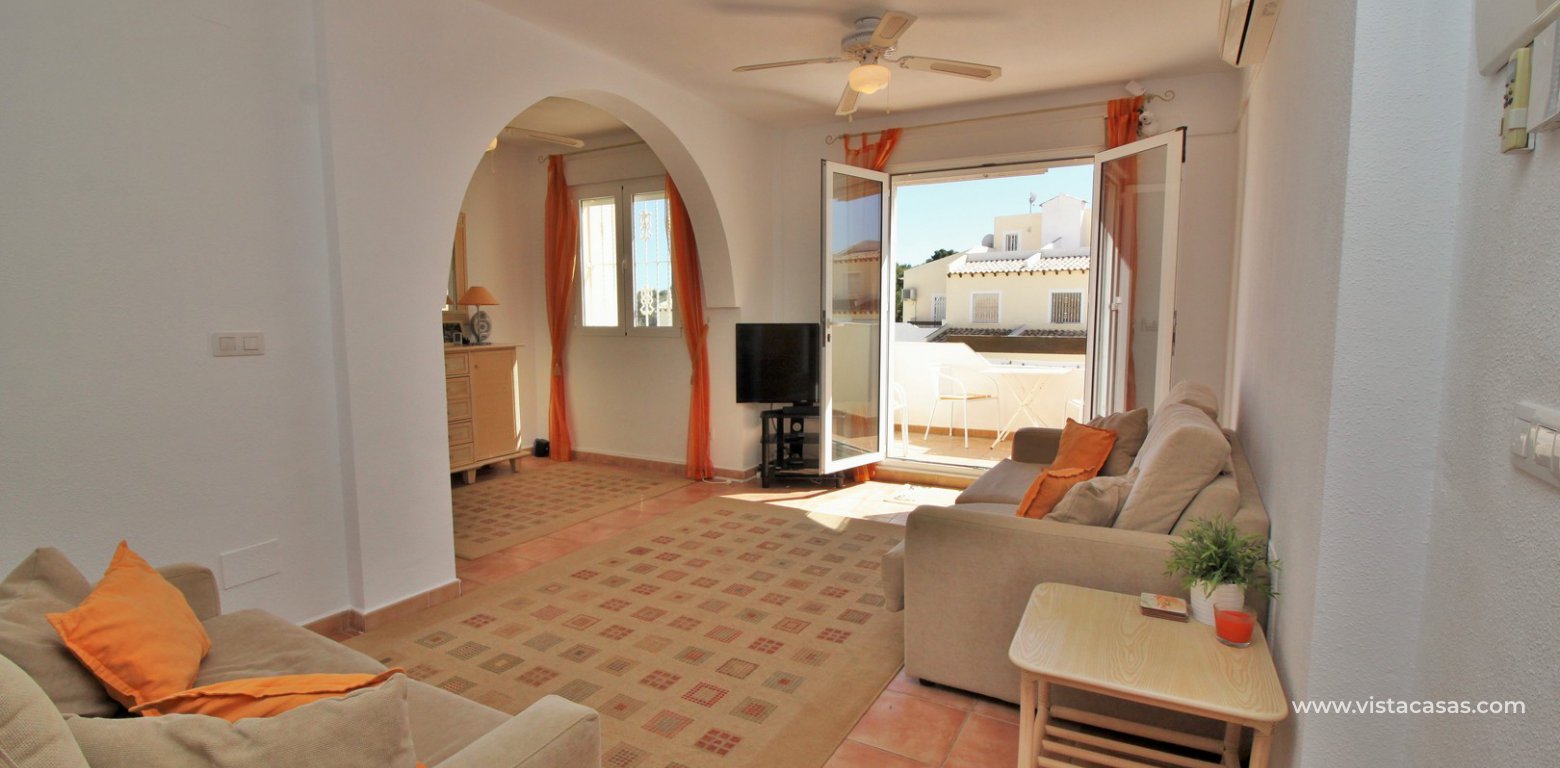 South facing 2 bedroom top floor apartment with golf views for sale in Panorama Golf Villamartin lounge