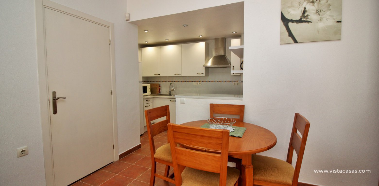 Ground floor apartment with communal pool for sale Panorama Golf Villamartin dining area