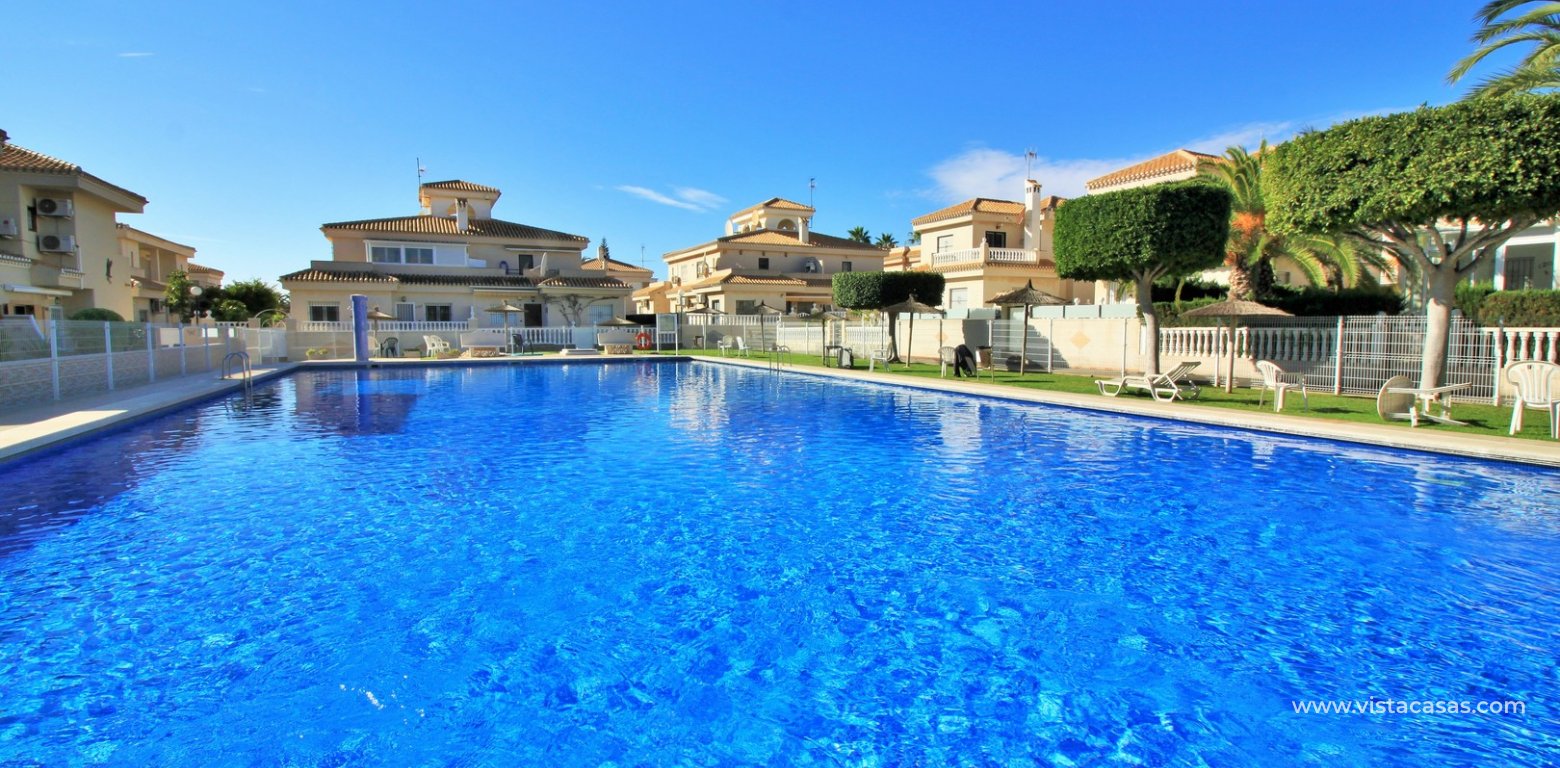 South facing townhouse for sale Playa Flamenca Vistacasas communal pool swimming pool