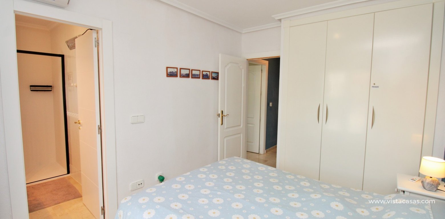 Top floor apartment with sea and pool views in for sale in Las Violetas Villamartin master bedroom fitted wardrobes